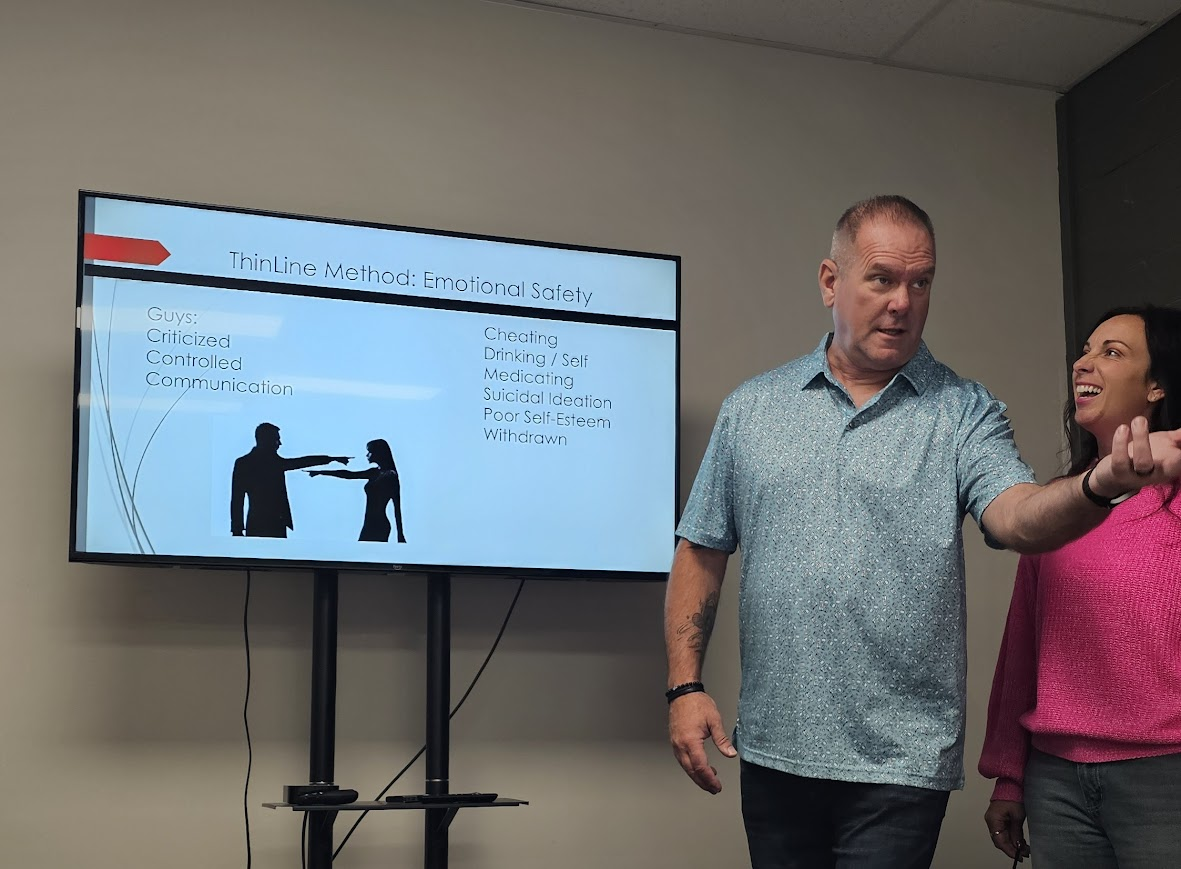 Paul and Heather teaching the ThinLine Method on emotional safety at an in-person mastermind